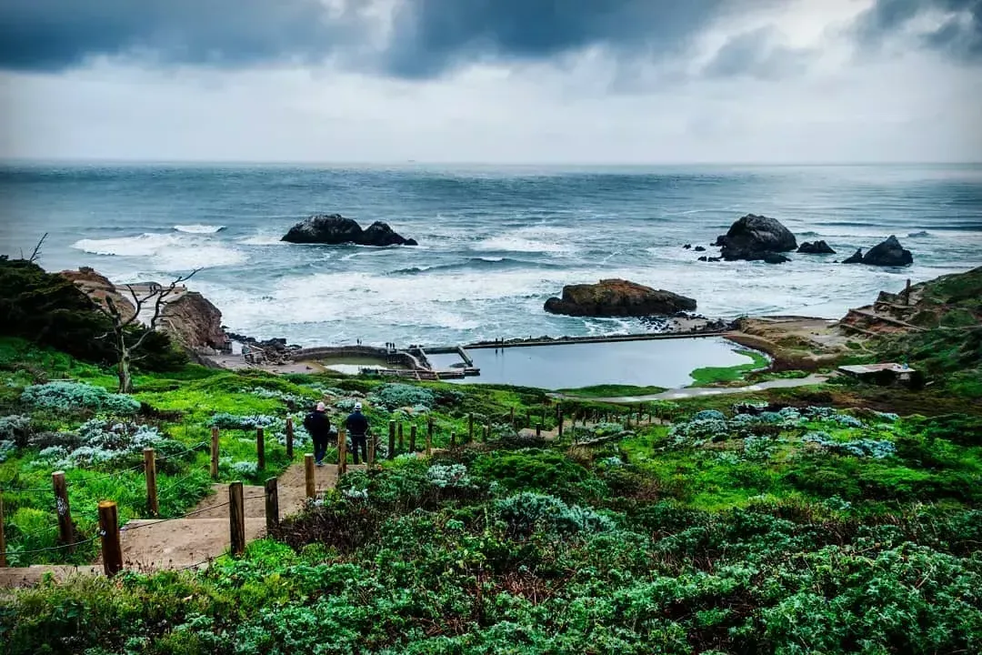 Hikers explore San Francisco's Sutro Baths near the Pacific Ocean